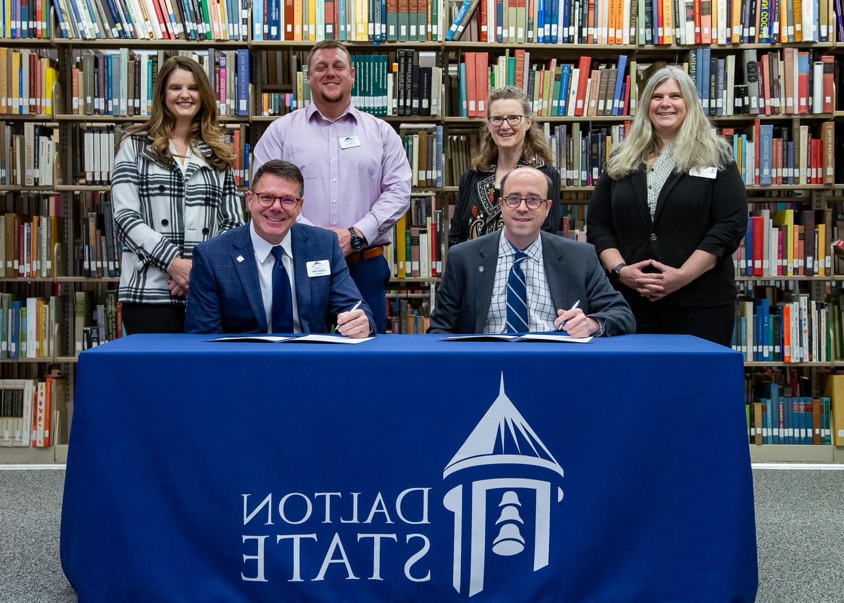 Dalton State College and Catoosa County Public Schools (CCPS) have created a new partnership to enhance the region's teacher workforce pipeline. Dalton State President John Fuchko, seated at left, and CCPS Superintendent Chance Nix, seated at right, signed the partnership agreement in a ceremony Jan. 7. Pictured standing from left are Gina Kertulis-Tartar, interim provost and vice president for academic affairs for Dalton State; Sharon Hixon, dean of the Dalton State School of Education; AJ Daniel, CCPS director of human resources; and Melissa Butler, CCPS assistant superintendent and director of secondary education.